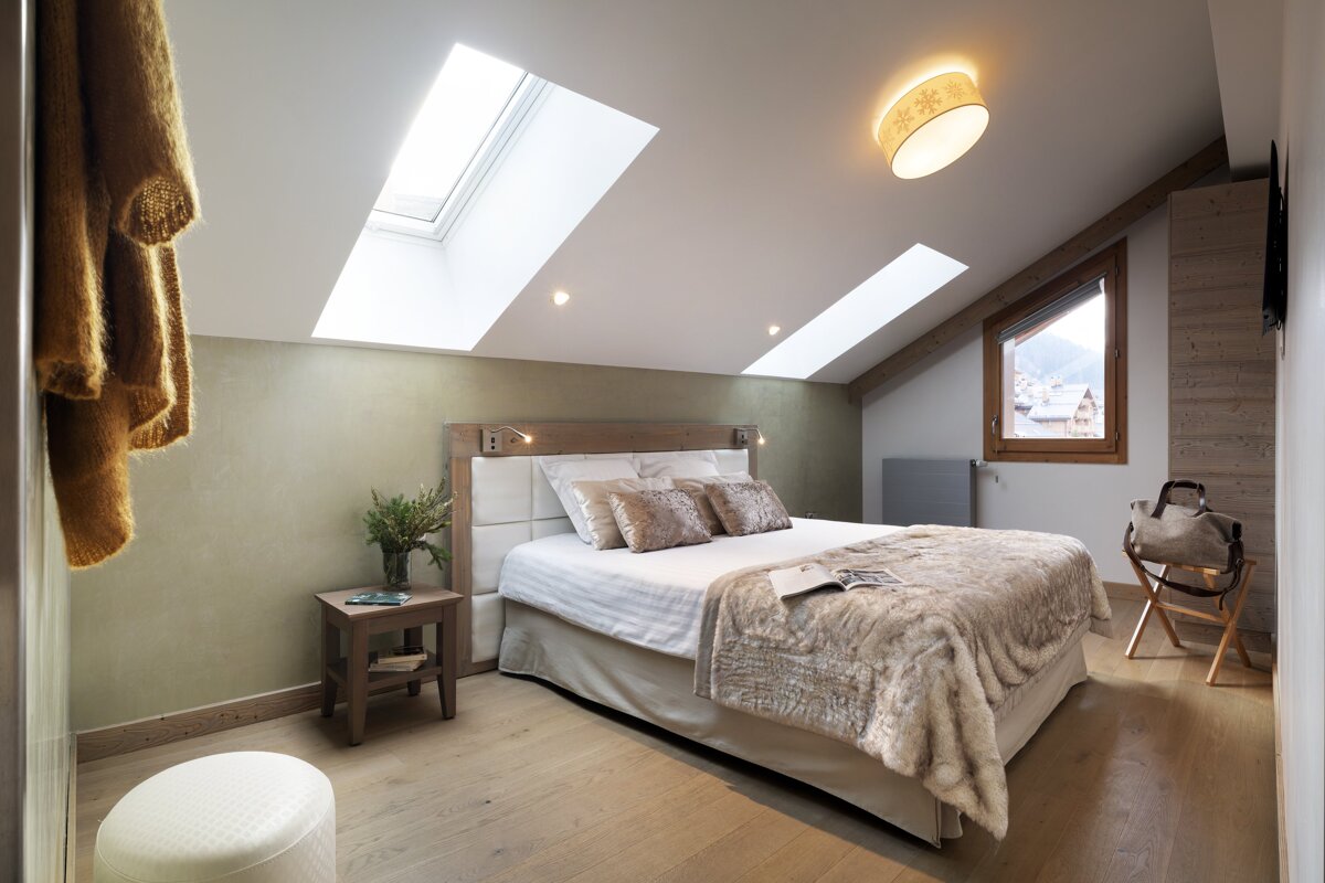 A bedroom with a large bed and a window