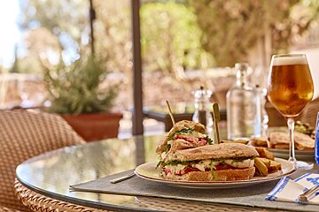 A sandwich and a glass of beer on a table