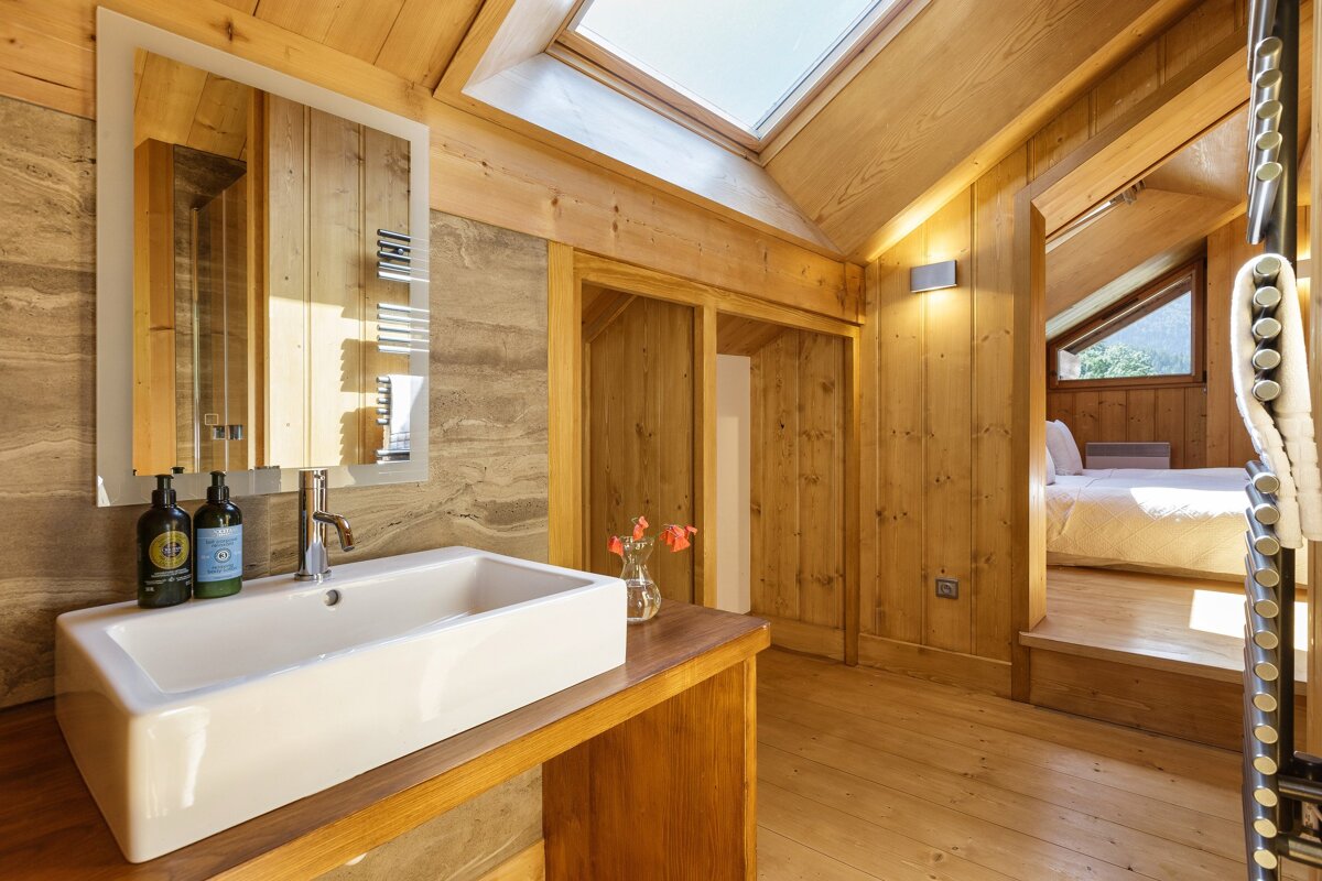 A bathroom with a sink and two bottles of lotion