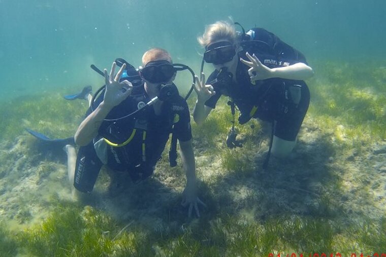 two divers giving the OK signal under water