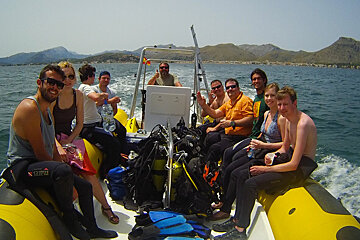 people on a boat heading off for a dive