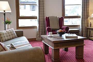 A living room with a couch a chair and a coffee table