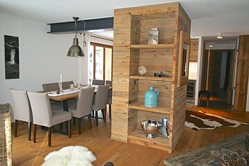 A wooden shelf with a blue vase on it