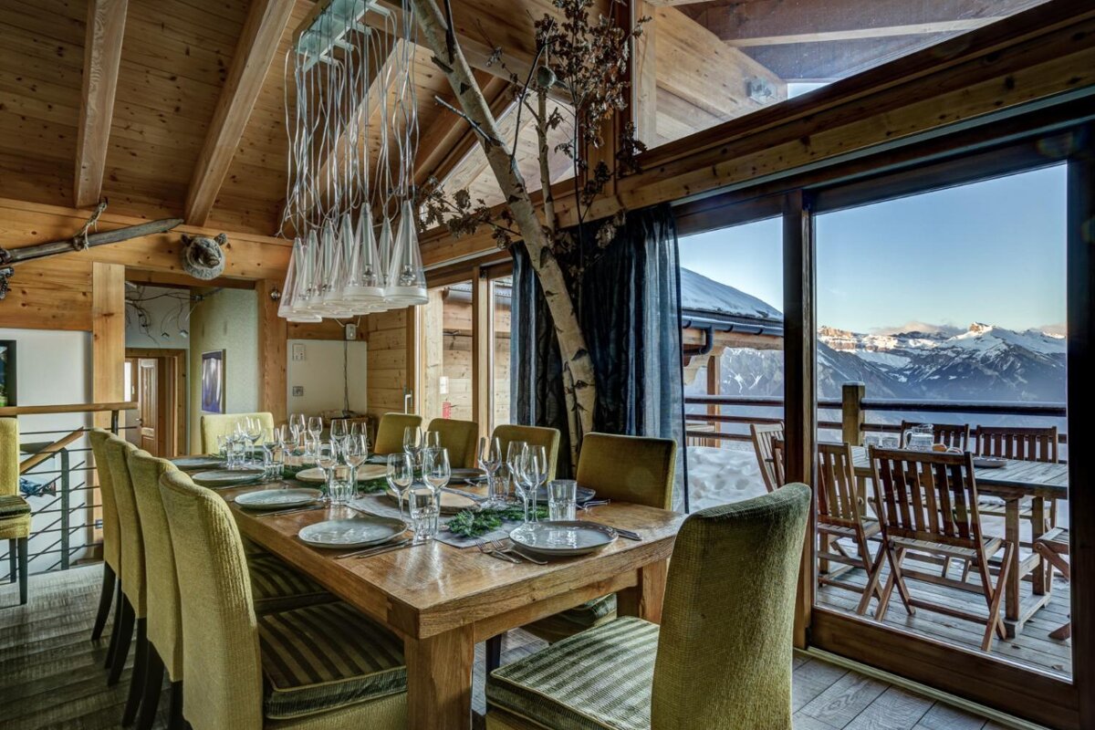 A dining room table with plates and glasses on it