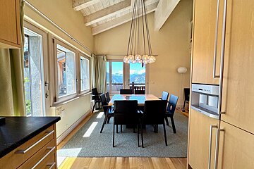 A dining room with a table and chairs in it