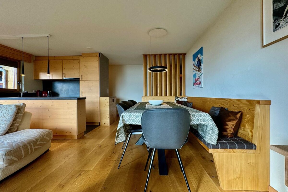 A living room with a dining table and chairs