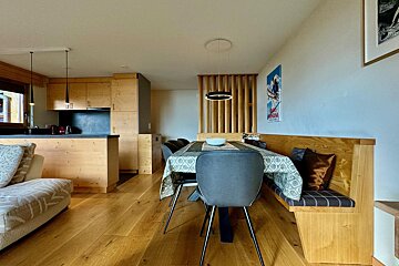 A living room with a dining table and chairs