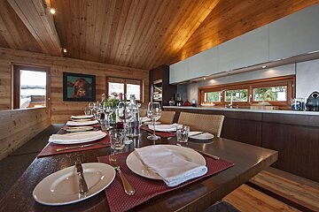 A dining room table with plates and glasses on it