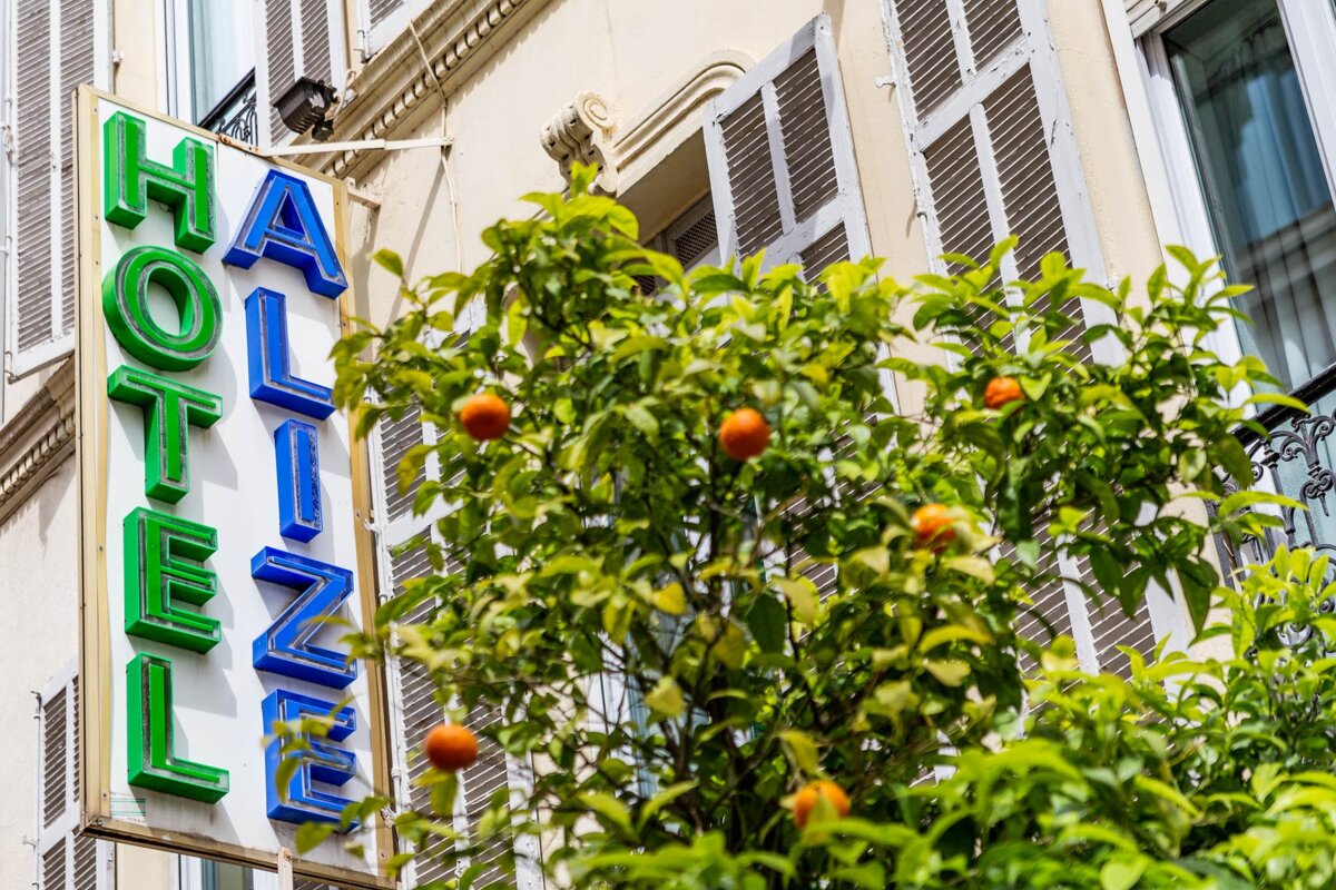 A building with shutters and a sign that says hotel