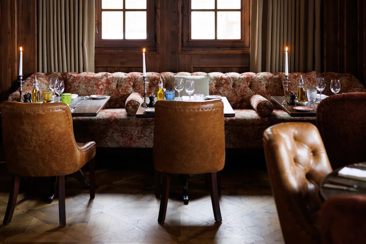 A dining room with tables and chairs and candles