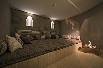 A room with a couch and pillows on it
