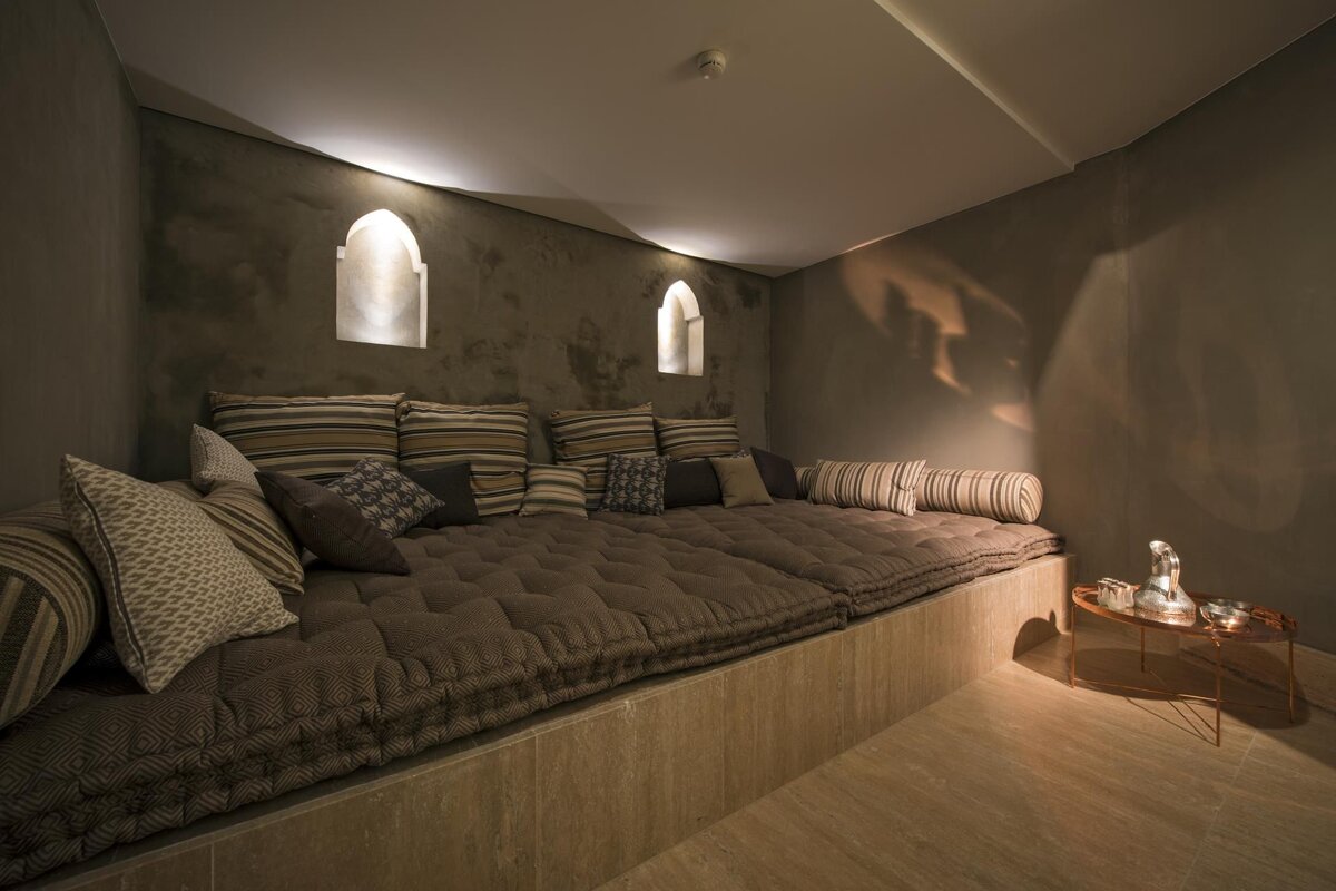 A room with a couch and pillows on it