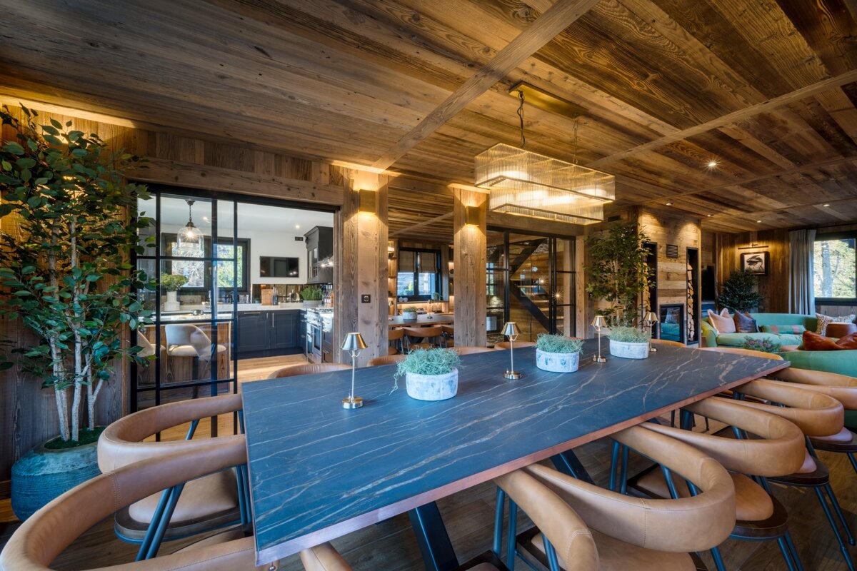 A dining room with a marble table and chairs