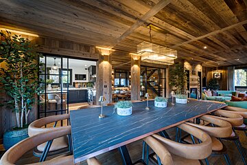 A dining room with a marble table and chairs