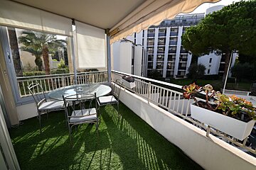 A balcony with a table and chairs on it