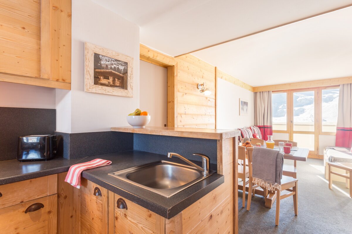 A kitchen with a sink and a toaster oven