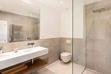 A bathroom with a toilet a sink and a shower