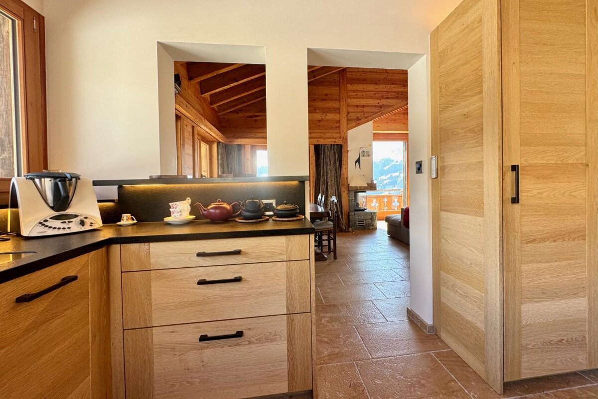 A kitchen with wooden cabinets and a blender on the counter