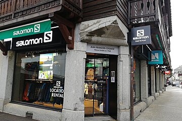 A salomon store is on the corner of a building