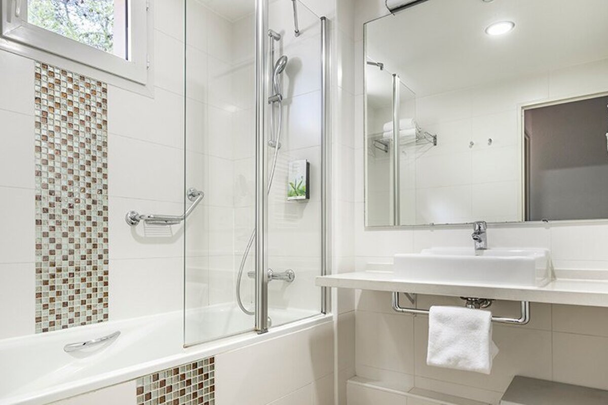 A bathroom with a bathtub and a sink