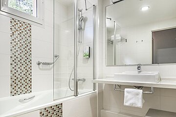 A bathroom with a bathtub and a sink