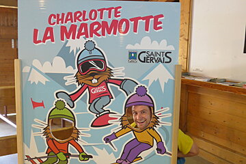 a man with his face in the cut out of a marmotte