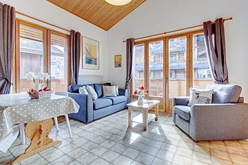 A living room with a blue couch and two chairs