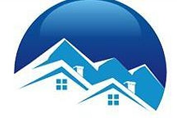 A logo of a mountain with houses on the roofs