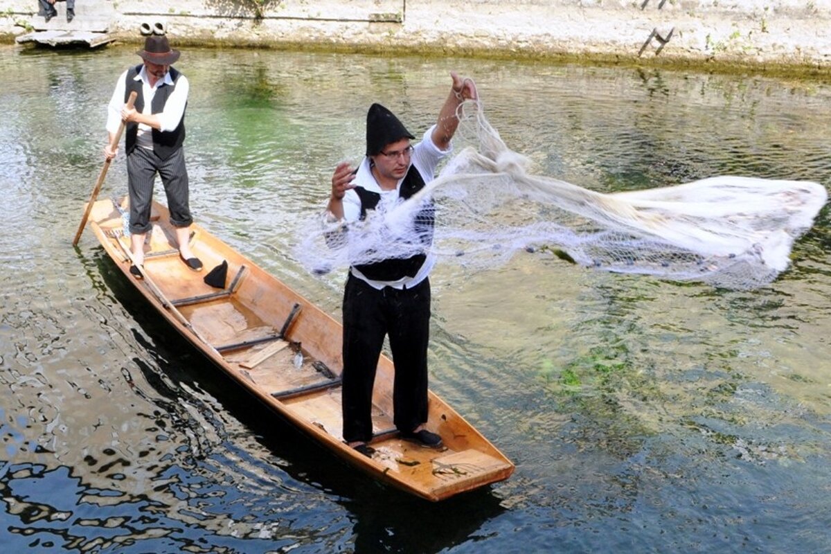 Fishermen casting their nets in the river sorgue provence