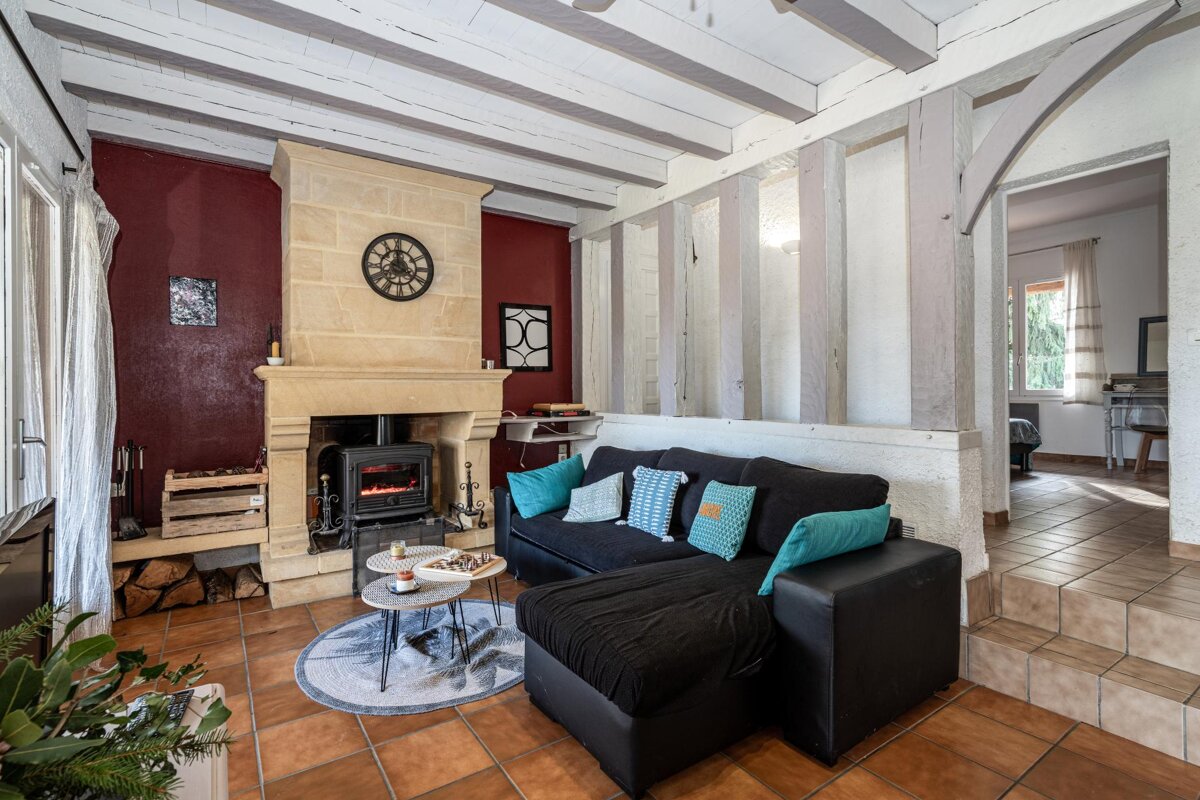 A living room with a fireplace and a black couch
