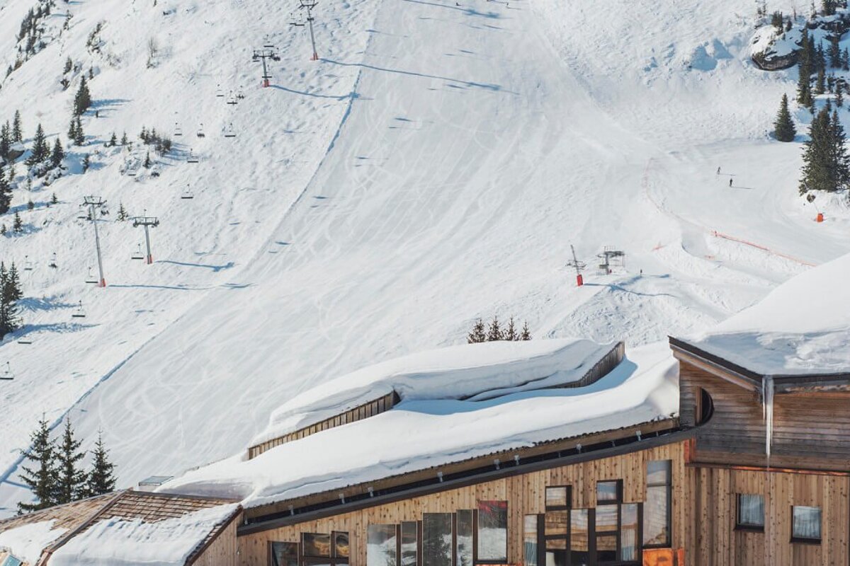 A snowy mountain with a ski lift in the background