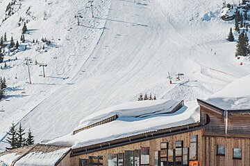 A snowy mountain with a ski lift in the background