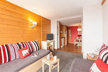 A living room with a couch and a pillow with a polar bear on it