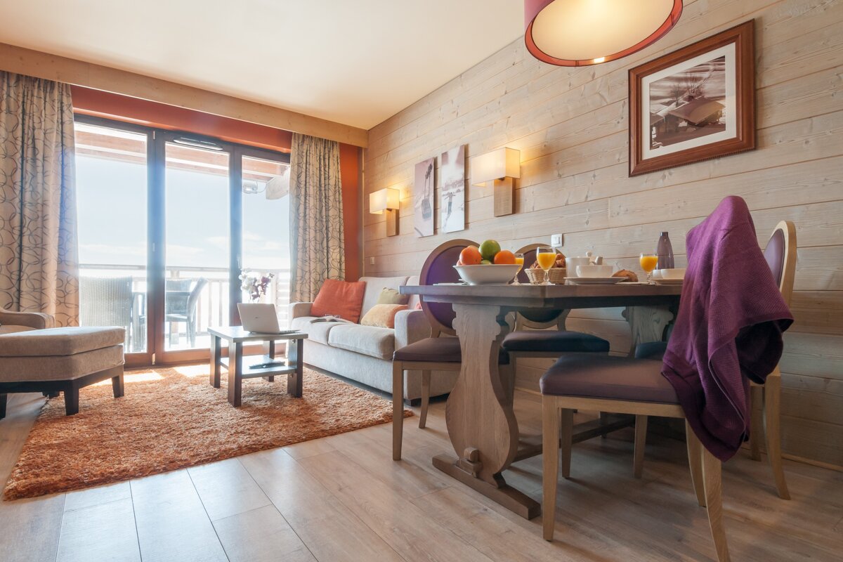 A living room with a couch a table and chairs