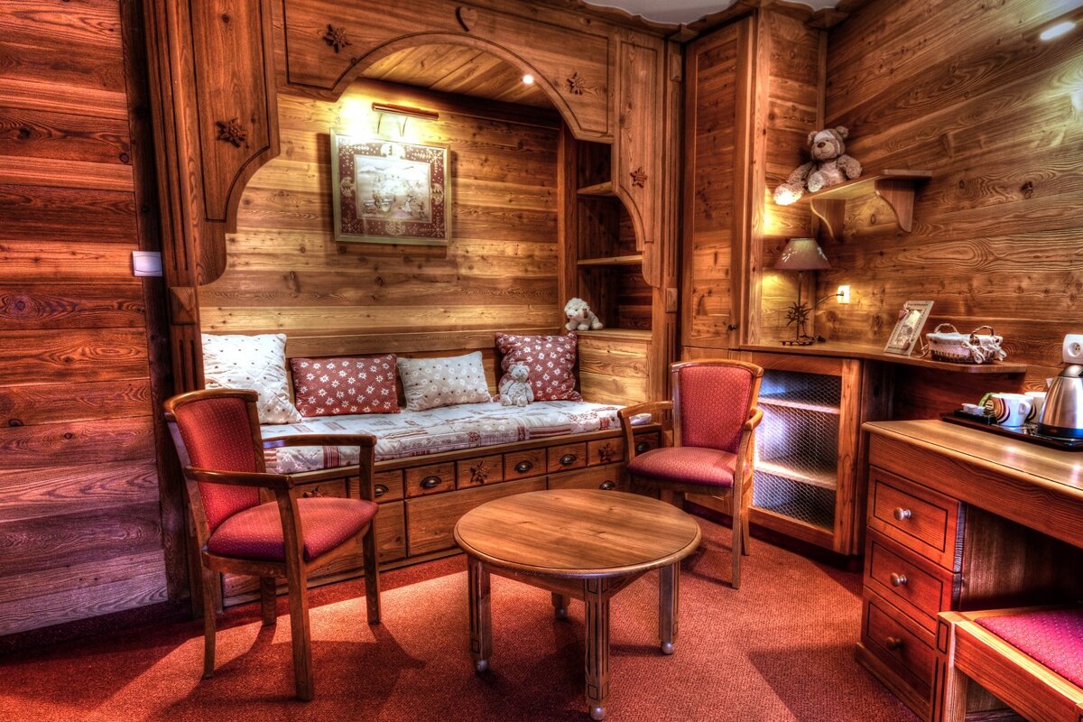 A wooden room with two chairs and a table