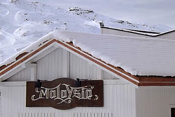 the outside of a nightclub with white wood panel walls