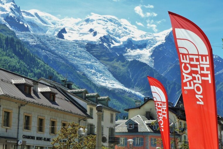 The north face flags are flying in front of a mountain