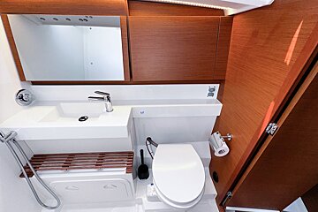 A bathroom with a toilet a sink and a mirror