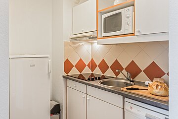 A small kitchen with a dishwasher and a microwave