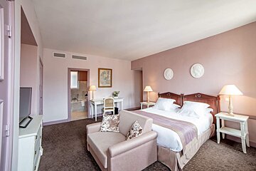 A hotel room with two beds and a chair