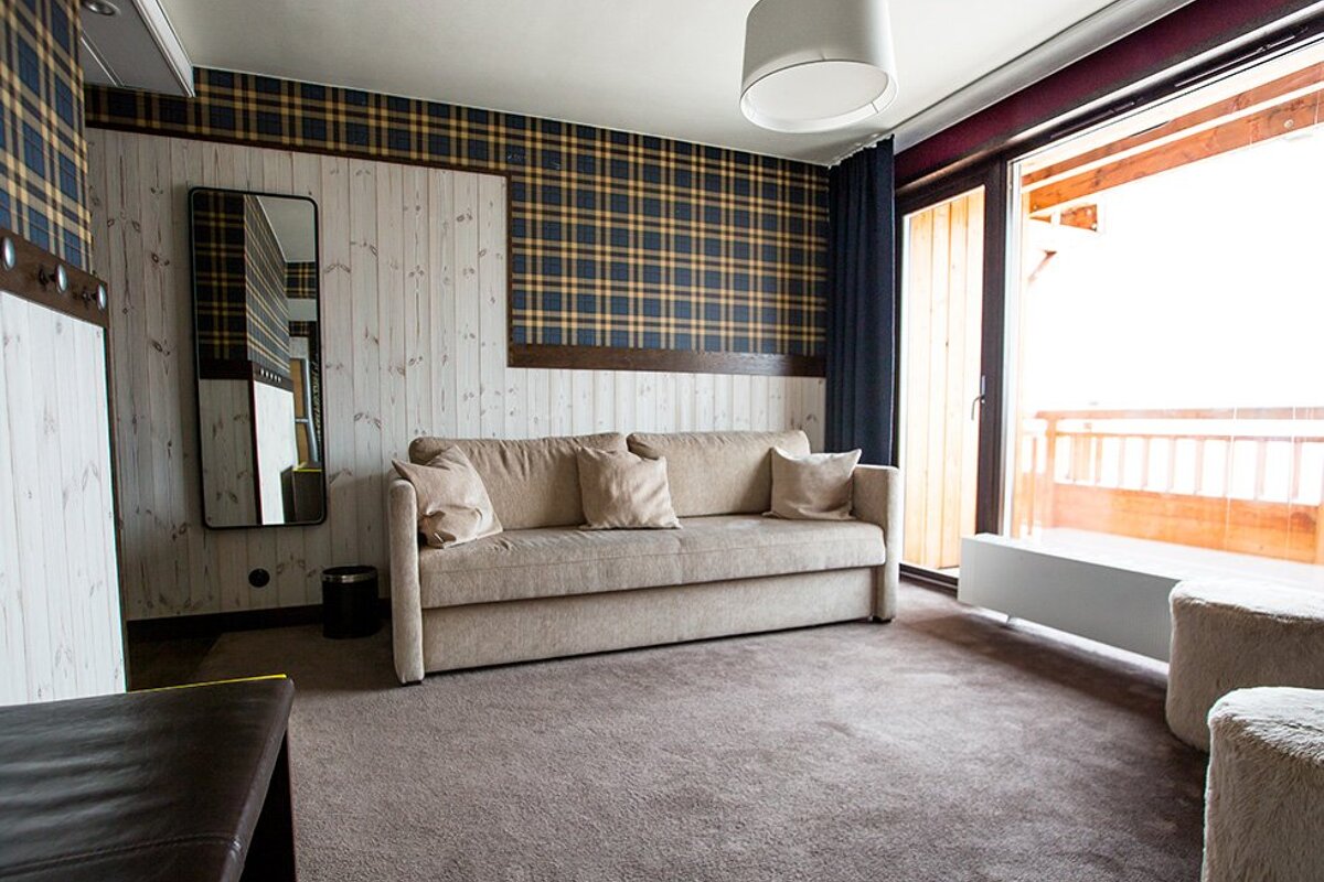 A living room with a couch and a mirror