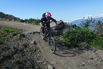 a mountain biker going over a rock drop