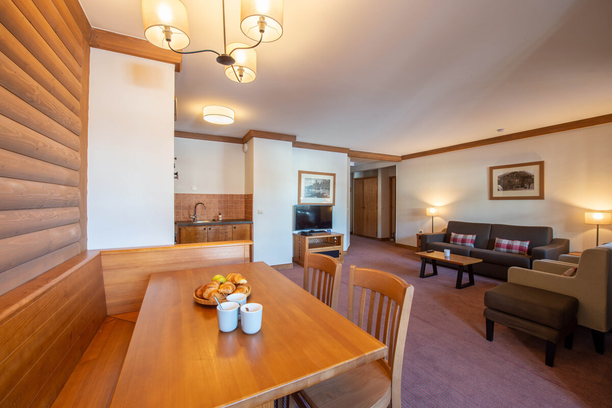 A living room with a table and chairs and a couch