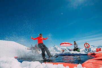 a skier going over a water slide