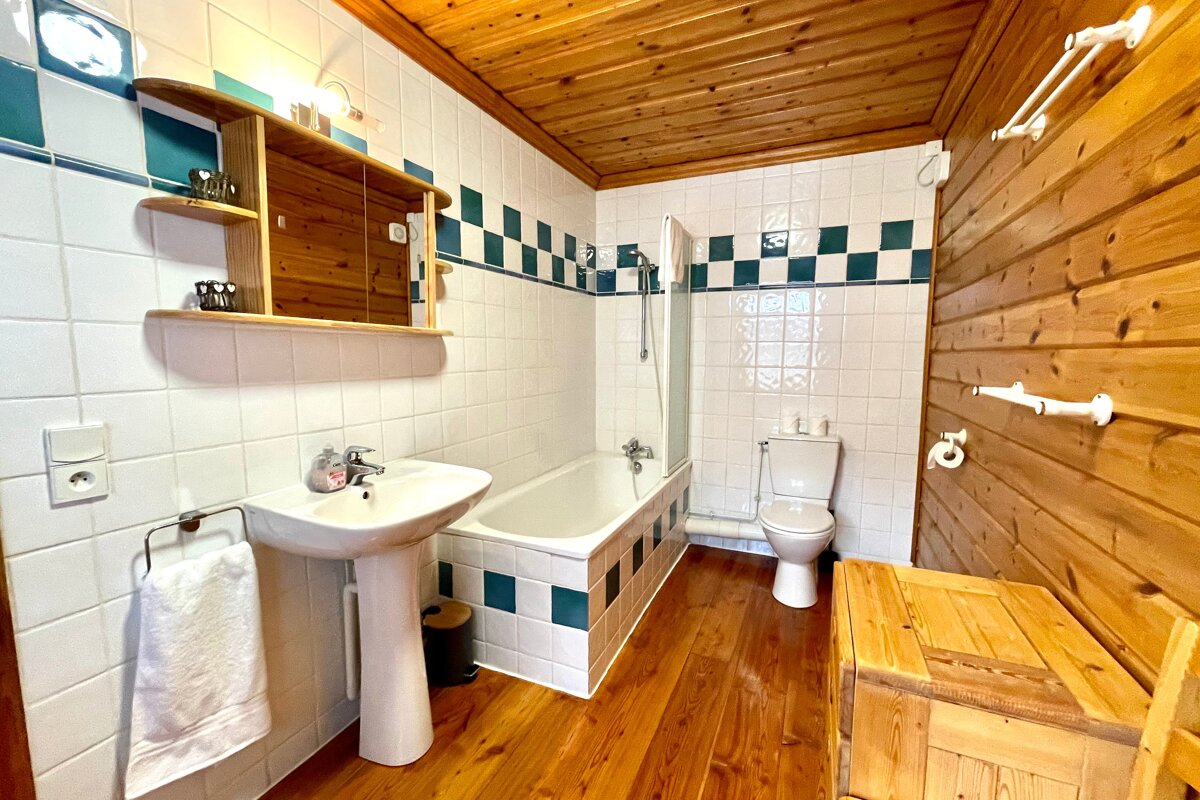 A bathroom with a sink toilet and bathtub