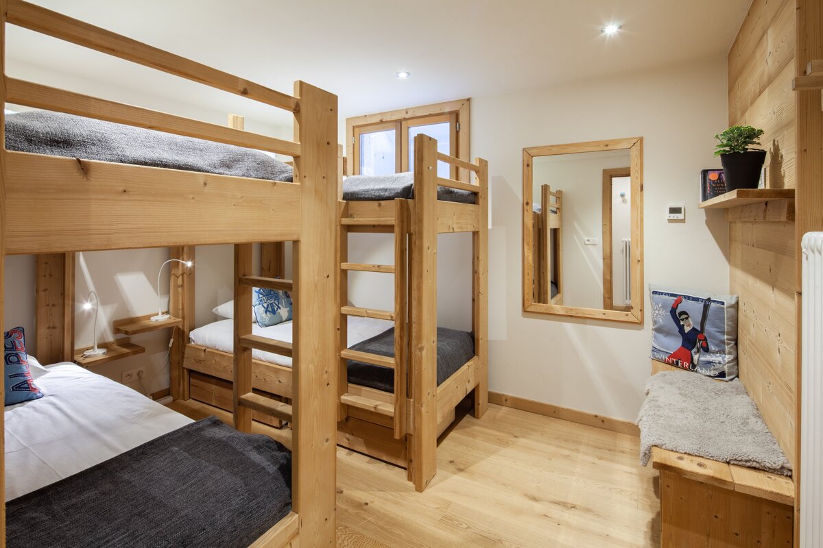 A bunk bed with a ski poster on it