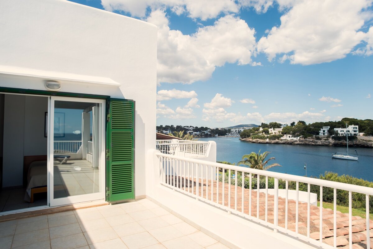 A balcony with a view of a body of water