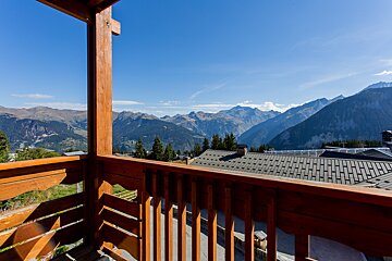 A balcony with a view of a mountain range