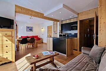 A living room with a couch a table and a television