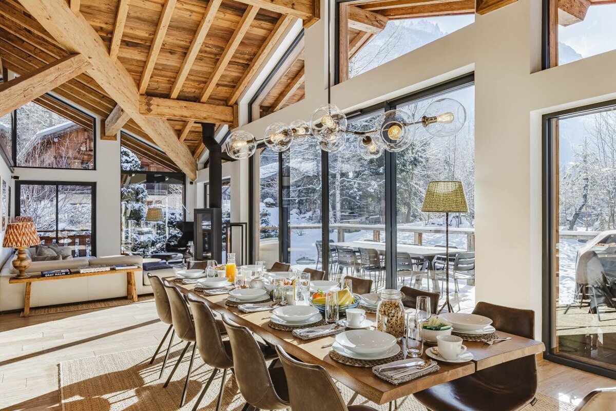 A dining room table with plates and glasses on it